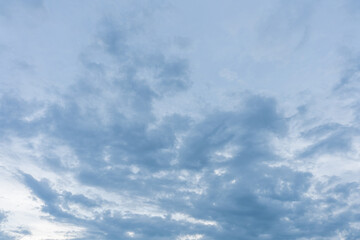 Obraz premium Fluffy white clouds drift across a bright blue summer sky