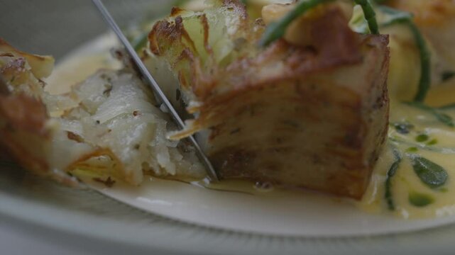 Close up of slicing the cod meat in a plate