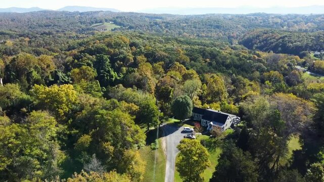 Aerial footage of the dense woods in Fincastle town on a sunny day in Botetourt, Virginia, USA
