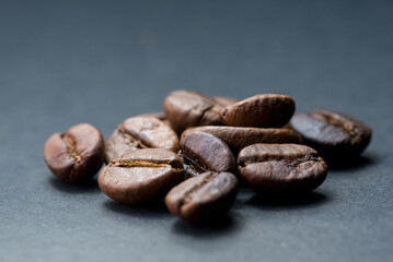 coffee in white cup and coffee beans are the background.