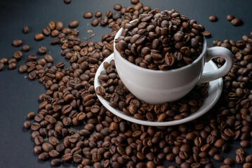 coffee in white cup and coffee beans are the background.