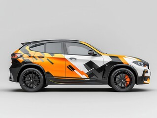 Fototapeta premium Side view of a stylish SUV featuring a dynamic geometric wrap design in orange, black, and white, against a neutral background. 