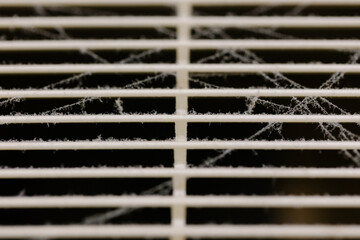 Very dirty and dusty white plastic ventilation grill. Ventilation shaft in the apartment. dirty air filter. House cleaning concept