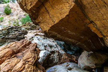 Majestic rocky cliff face, showcasing rugged natural rock formations and earthy tones