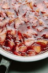 Plum and apple jam. Cooking cooking jam in a frying pan. Homemade jam with sugar syrup. The process of cooking, boiling berries for canning.Close-up top view