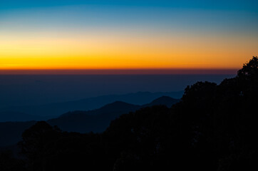 The beautiful sunrise at Doi intanon national park, Chiang Mai in the morning.Sun is rising from the hill to shy with beautiful yellow orange light.
