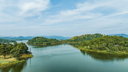 Obraz premium Kaeng Krachan dam with lake view and many green moutain, blue sky background. Kaeng Krachan Dam national park, Phetchaburi province, Thailand in aerial view from drone.
