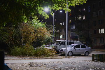 Night city landscape, village houses, road, sky and trees on a summer evening