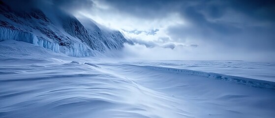 Obraz premium A snowy landscape under dramatic clouds in a remote area showcasing the serene beauty of winter’s chill during daylight