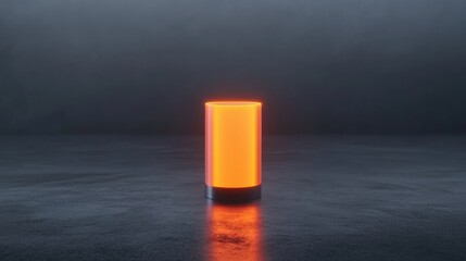 A small orange object is lit up in a dark room