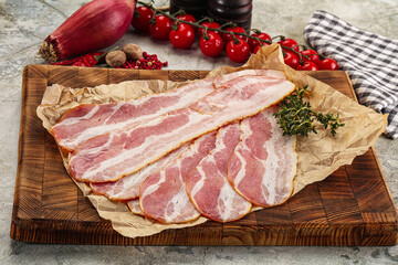 Sliced pork bacon over board