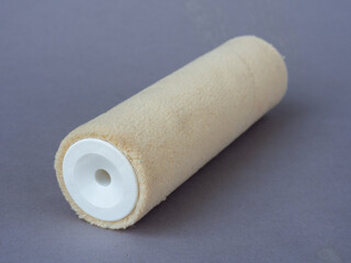 Lacquer roller on a gray background. Paint roller accessories. Velour roll for painting. Paint rollers for suitable for finishing smooth surfaces 