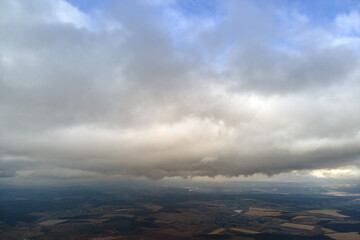 Aerial view from high altitude of earth covered with puffy rainy clouds forming before rainstorm