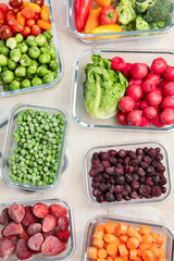 Boxes with fresh raw vegetables on table.