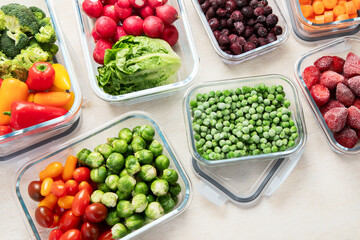 Boxes with fresh raw vegetables on table.