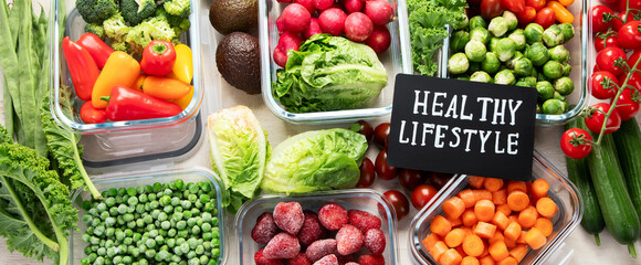 Boxes with fresh raw vegetables on table.