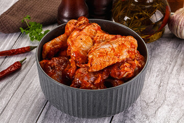 Raw marinated buffalo chicken wings