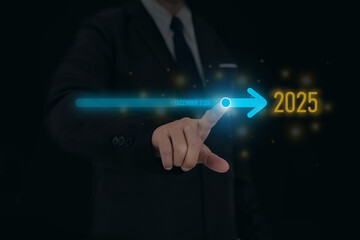 New year 2025 concept, a man's hand points to a glowing arrow that is ending December 2024 and entering 2025.