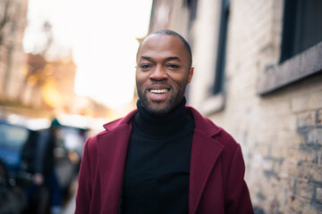 Fototapeta premium Fashion portrait of black man in city in modern spring or fall season outfit.