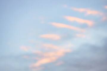 A beautiful sky tinted by the sun leaving vibrant shades of gold, pink, blue and multicolored. Clouds in the twilight evening and morning sky. Cloudy sky background in the evening, and during the day.