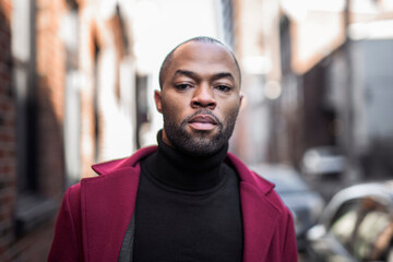 Fashion portrait of black man in city in modern spring or fall season outfit.