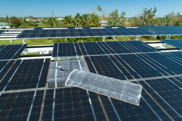 Destroyed by hurricane wind solar panels installed over parking lot canopy shade for parked cars...