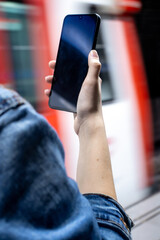 Pretty young girl looking at her phone in the train station