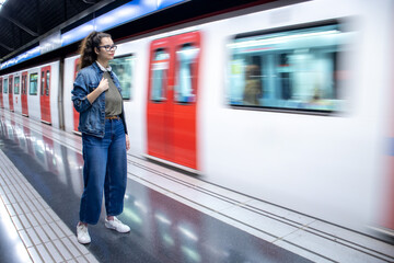 Pretty young girl waiting for the train to arrive