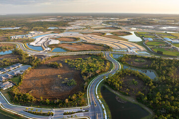 Development of real estate market in the USA. Aerial view of large construction site with building...