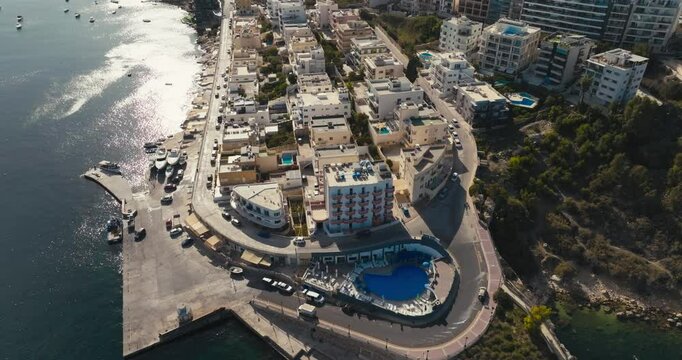 Aerial view of Bugibba on the island of Malta. Tourist town on the shore of the Mediterranean Sea in the cityscape. High quality 4k footage