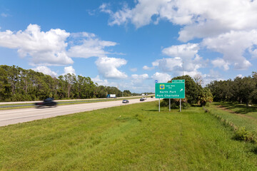 Highway interchange exit sign with direction to North Port and Port Charlotte in Florida....