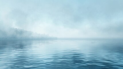 Fototapeta premium A serene lake shrouded in fog, with a distant line of trees barely visible through the mist.