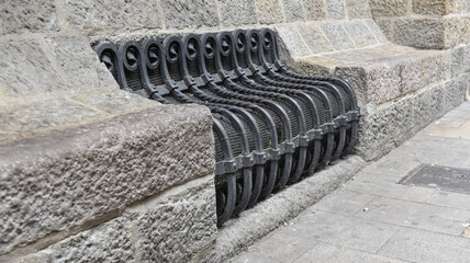 an iron bench in the old streets of Barcelona Spain