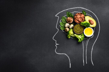 healthy food for brain functions and memory, mental wellness. Chalk drawing of brain on black...