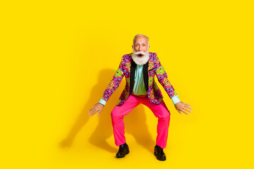Full body photo of nice senior male dance knees dancing wear trendy colorful pink fancy outfit isolated on yellow color background
