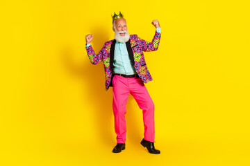 Full length photo of attractive retired man winning raise fists king wear colorful pink fancy clothes isolated on yellow color background