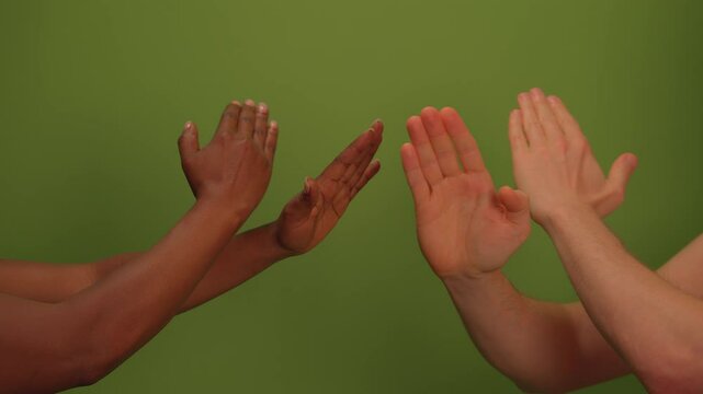 Diverse hands gesture expressively against a vibrant green background, showcasing unity