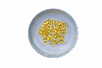 Cod- liver oil capsules in white plate