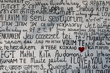 I love you in multiple languages on a textured background.