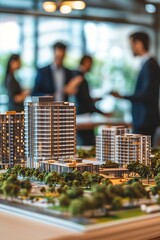 Obraz premium Architects discussing residential project on architectural model in office meeting