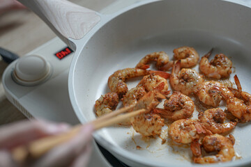 Spicy Shrimp Cooking in a Hot Pan, A Delicious Seafood Dish in the Making