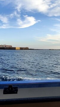 Boat approaching tabarca island in the mediterranean sea