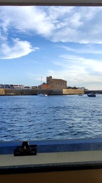 Tourist waving hand approaching tabarca island by boat