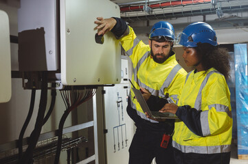 engineering technician Setting up the solar panel inverter in the electrical room Service engineer installs solar cells on factory roofs Concept of clean energy and renewable energy