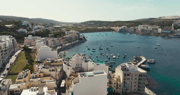Beautiful Aerial Footage of Bugibba Malta Highlighting Mediterranean Urban Coastline Tourist Beaches and Marina Full of Yachts and Boats. High quality 4k footage