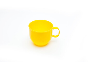 a small yellow plastic mug on a white background.