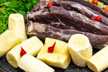 Traditional rustic tropical Brazilian dish, sun-dried beef with green beans, cassava, biquinho pepper. Creative rustic photography
