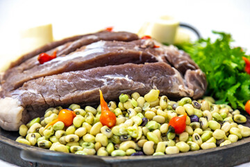 Traditional rustic tropical Brazilian dish, sun-dried beef with green beans, cassava, biquinho pepper. Creative rustic photography