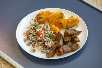 Traditional rustic tropical Brazilian dish, sun-dried beef with green beans, cassava, biquinho pepper. Creative rustic photography