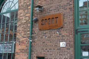 Naklejka premium The Sport Gallery sign at The Distillery Historic District, a tourist attraction, located at 55 Mill St in downtown east Toronto, Canada